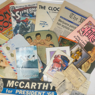 Vintage ephemera lot with comics, postcards, and old newspapers