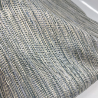 Striped upholstery fabric in blue, green, and beige with silver shimmer, shown with ruler for scale.
