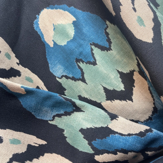 Vervain Asante fabric swatch in abstract blue, teal, and beige pattern on dark background