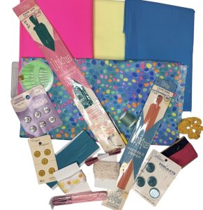 brightly colored fabric and vintage buttons and notions laid out