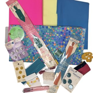 brightly colored fabric and vintage buttons and notions laid out